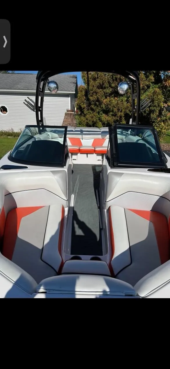 Slide: The Image of 2014 Moomba Mondo boat interior with white and orange seating, open bow design. - 2