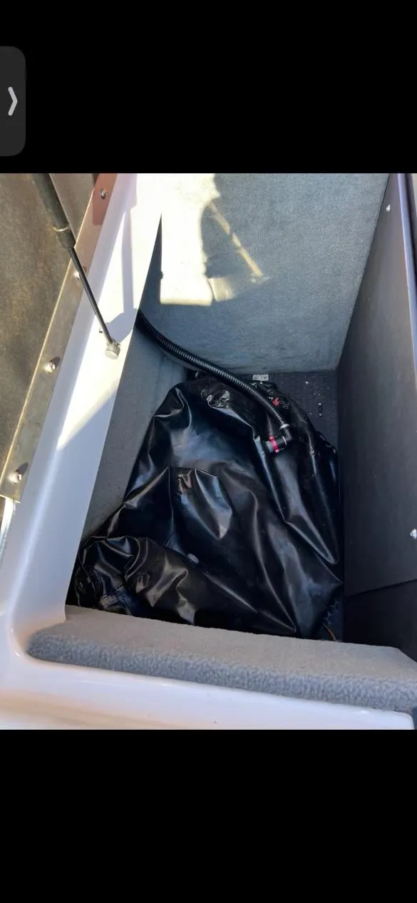 Slide: The Image of 2014 Moomba Mondo storage compartment with black interior lining. - 3