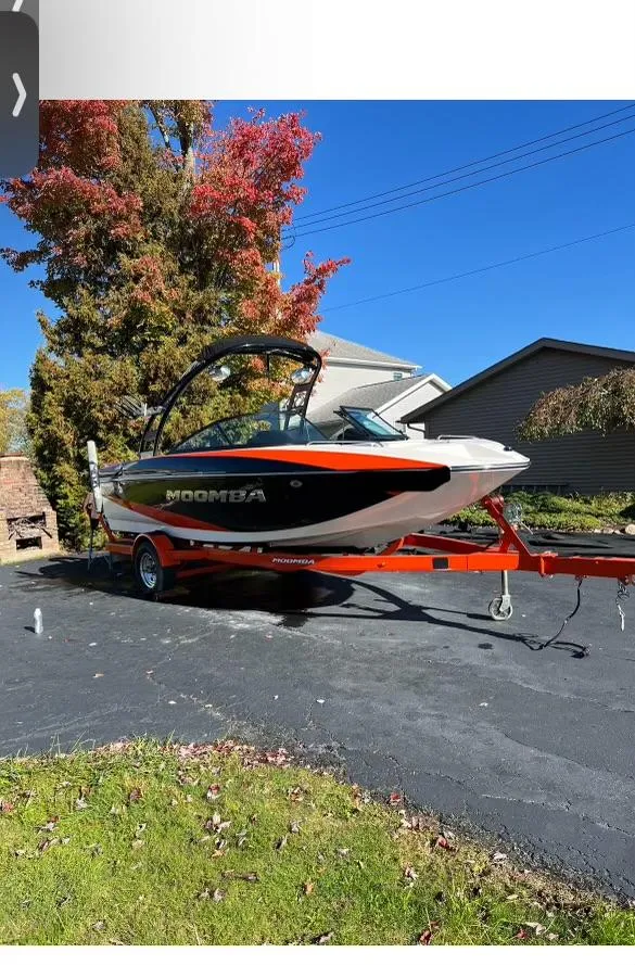Slide: The Image of 2014 Moomba Mondo boat on trailer, parked in driveway, vibrant autumn background. - 4