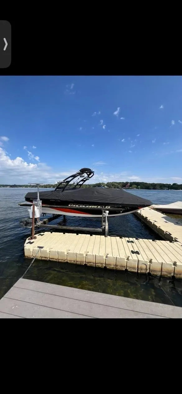 Slide: The Image of 2014 Moomba Mondo boat docked on a sunny lake. - 5