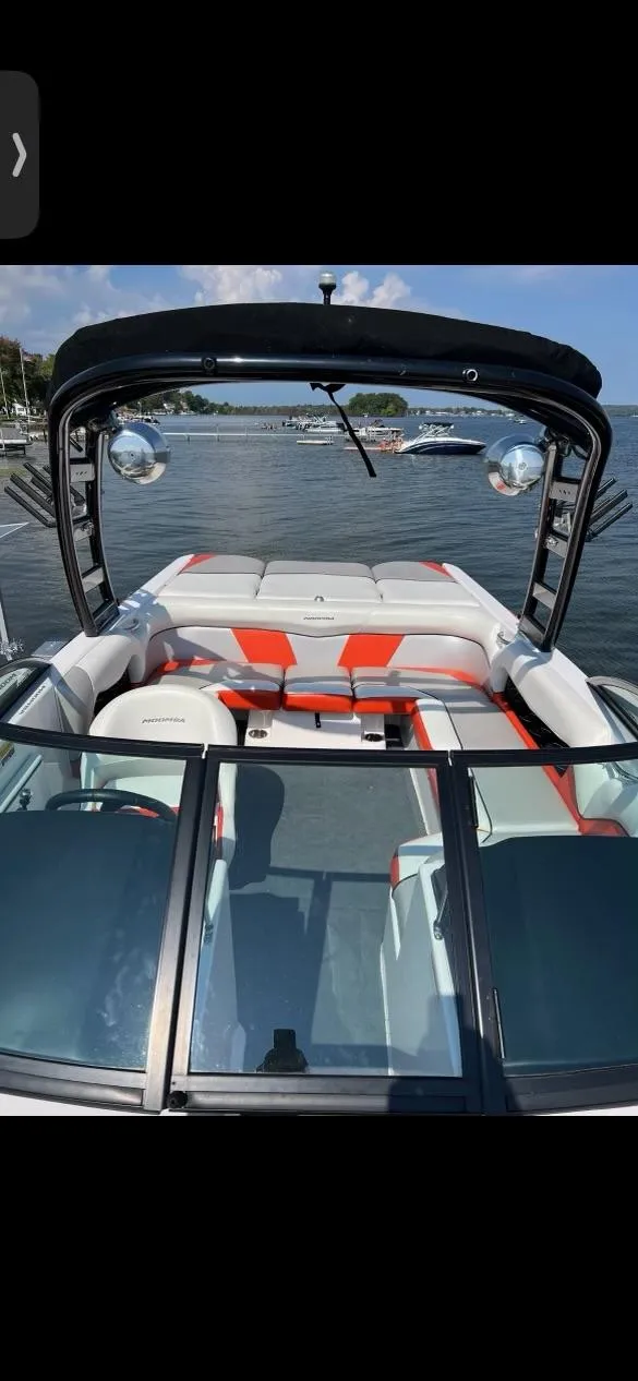 Slide: The Image of 2014 Moomba Mondo boat with sleek design on a sunny lake. - 8