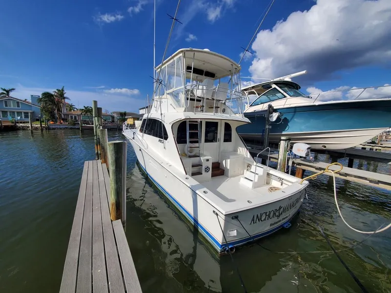 Slide: The Image of 1988 Post 46 Sportfish boat docked at marina under clear blue sky. - 1