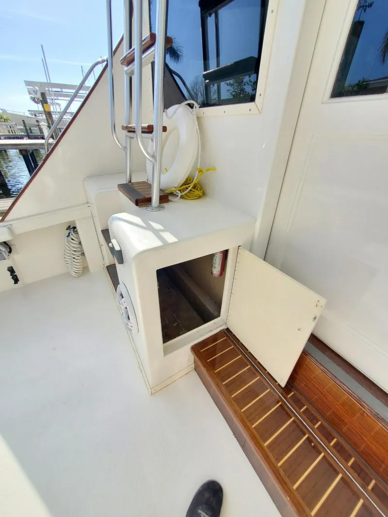 Slide: The Image of 1988 Post 46 Sportfish boat deck with storage compartment and ladder. - 13
