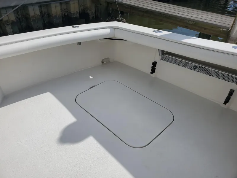 Slide: The Image of 1988 Post 46 Sportfish boat deck, spacious and clean, with storage hatch. - 15