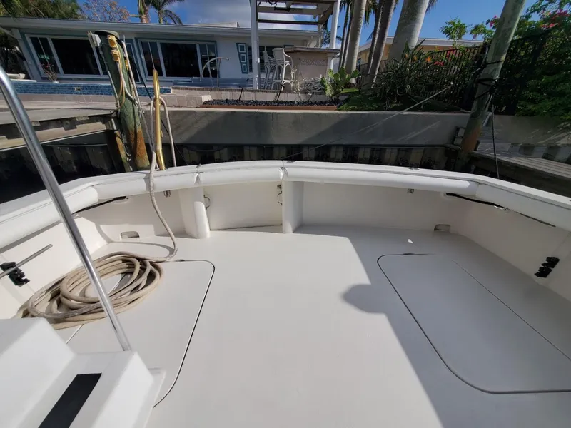 Slide: The Image of 1988 Post 46 Sportfish boat deck with clean, spacious layout and dockside view. - 16