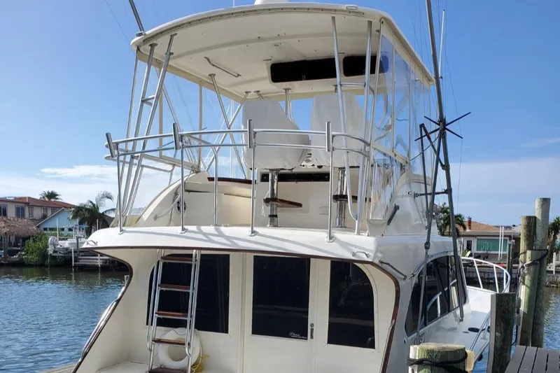 Slide: The Image of 1988 Post 46 Sportfish boat docked by waterfront homes. - 17