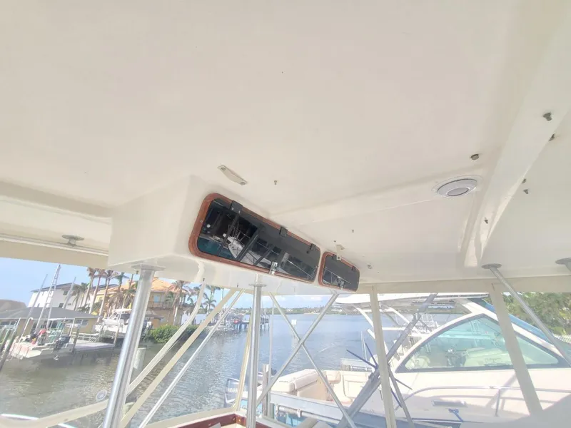 Slide: The Image of 1988 Post 46 Sportfish boat interior with overhead electronics and marina view. - 22