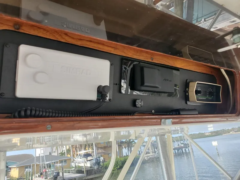 Slide: The Image of 1988 Post 46 Sportfish boat electronics panel with waterfront view. - 23