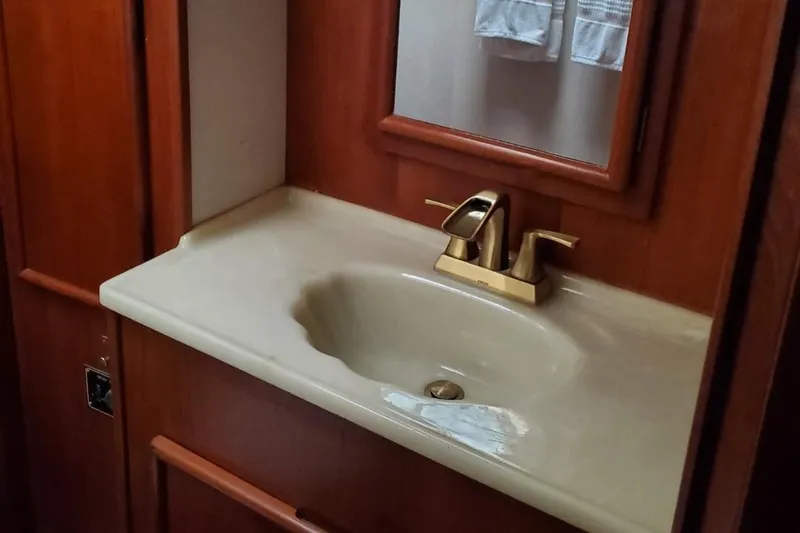 Slide: The Image of 1988 Post 46 Sportfish bathroom sink with wooden cabinetry and modern faucet. - 42