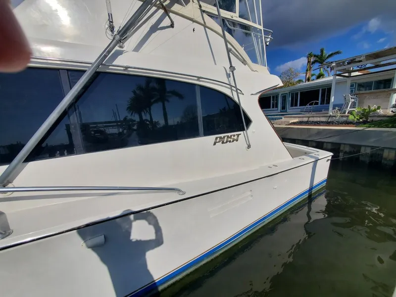 Slide: The Image of 1988 Post 46 Sportfish yacht docked near waterfront property. - 7