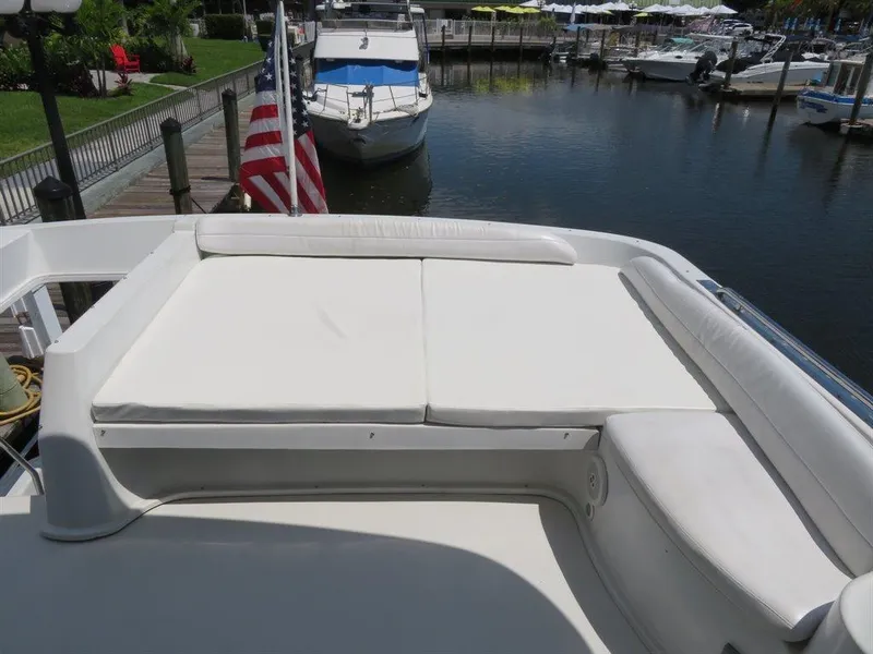 Slide: The Image of Bluewater Yachts Millennium Series 63, 2000 model, featuring spacious deck seating at marina. - 13
