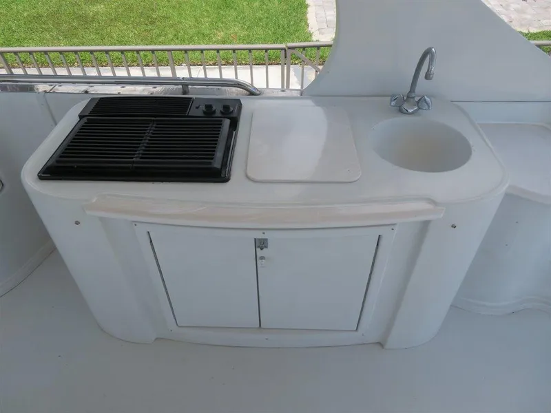 Slide: The Image of Outdoor kitchenette on 2000 Bluewater Yachts Millennium Series 63, featuring grill and sink. - 17