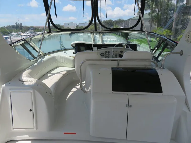 Slide: The Image of Cockpit of 2000 Bluewater Yachts Millennium Series 63 with white seating and control panel. - 20