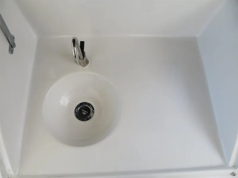 Slide: The Image of White sink with chrome faucet in Bluewater Yachts Millennium Series 63, 2000 model. - 23