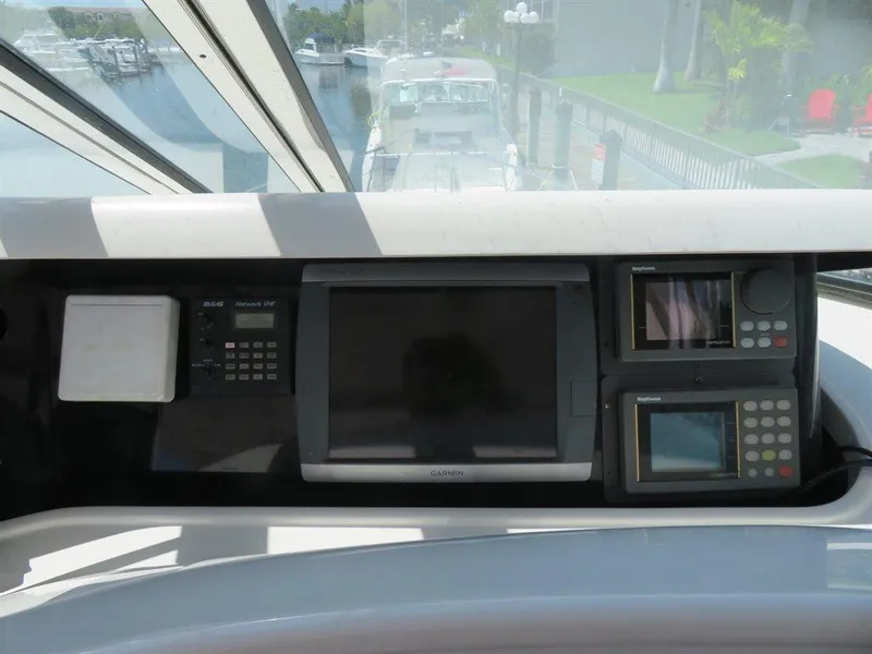Slide: The Image of Control panel of 2000 Bluewater Yachts Millennium Series 63, featuring navigation equipment. - 24