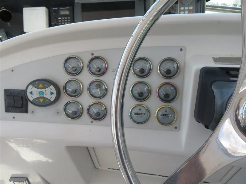 Slide: The Image of Dashboard of 2000 Bluewater Yachts Millennium Series 63 with gauges and controls. - 26