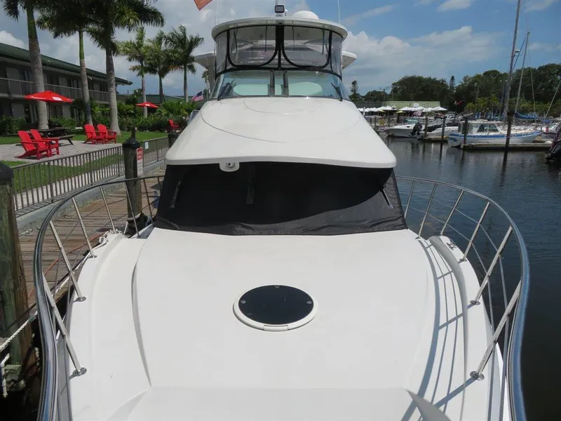 Slide: The Image of 2000 Bluewater Yachts Millennium Series 63 docked at marina, surrounded by palm trees. - 30