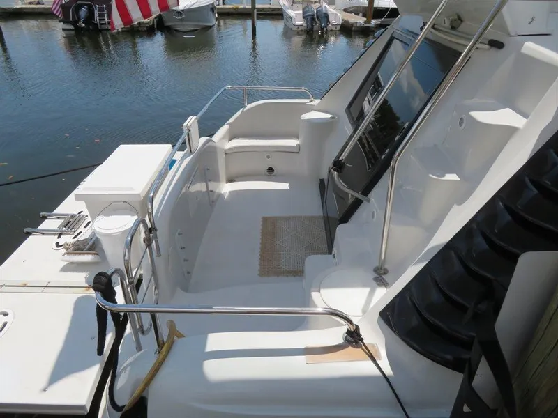Slide: The Image of 2000 Bluewater Yachts Millennium Series 63, sleek deck design, docked at marina. - 36