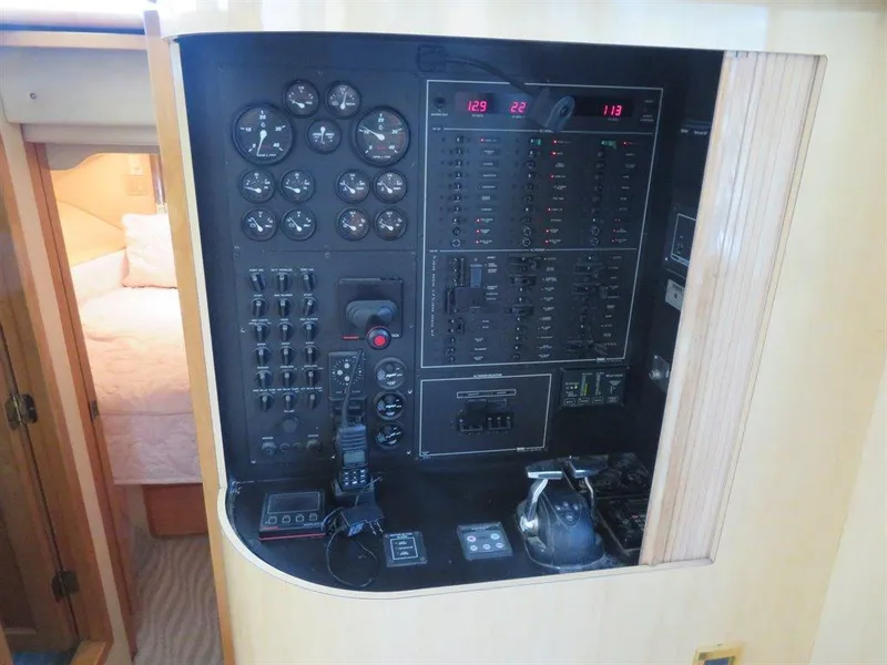 Slide: The Image of Control panel of a 2000 Bluewater Yachts Millennium Series 63, featuring gauges and switches. - 39