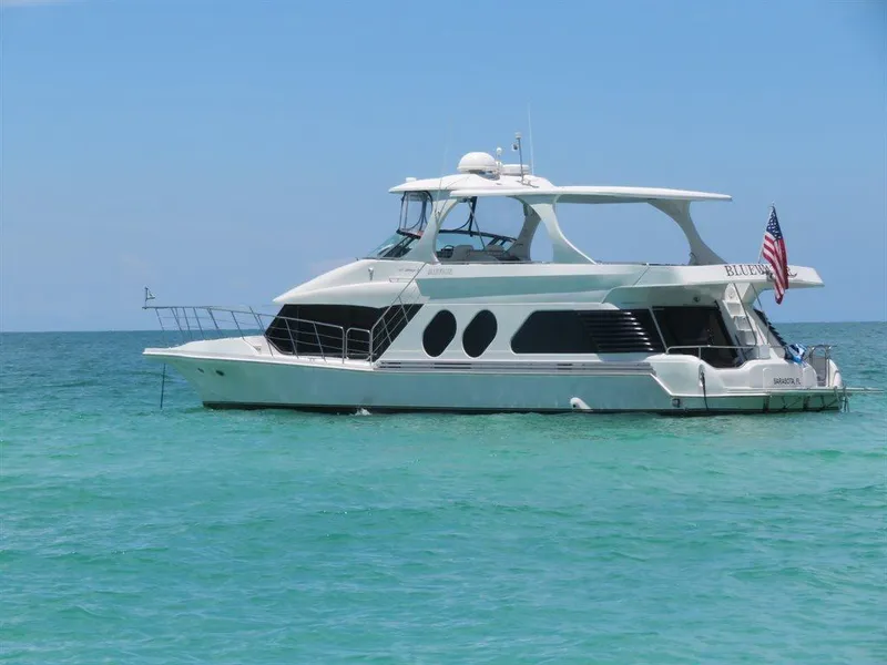 Slide: The Image of Bluewater Yachts Millennium Series 63, 2000 model, anchored in clear blue ocean waters. - 5