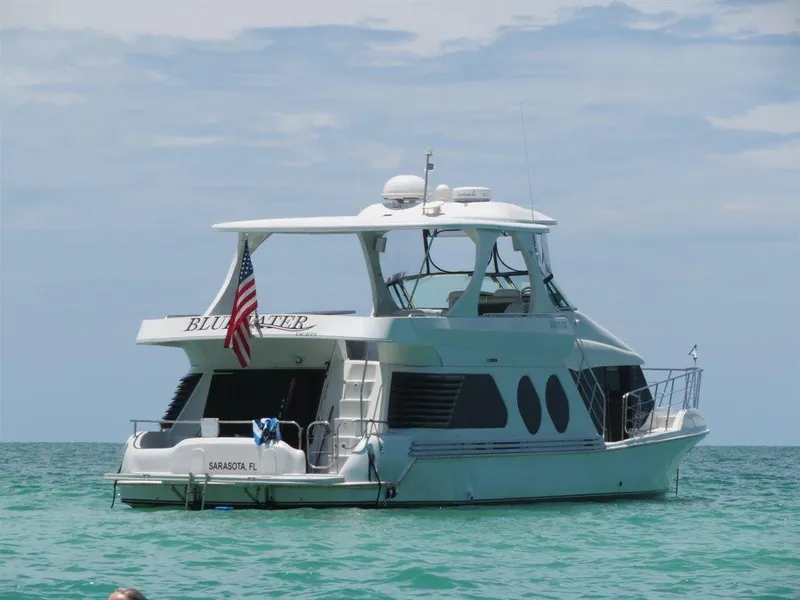 Slide: The Image of Bluewater Yachts Millennium Series 63, 2000 model, anchored in clear ocean waters. - 6