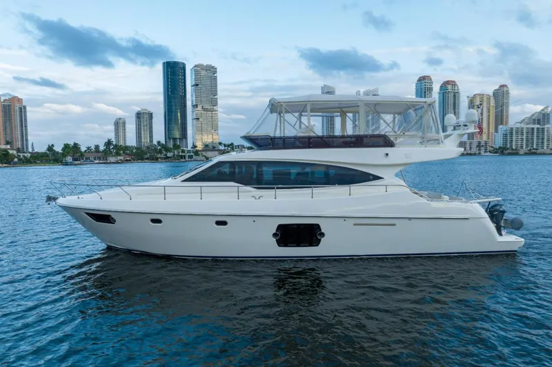Slide: The Image of Ferretti Yachts 530, 2014 model, cruising near city skyline on calm waters. - 0