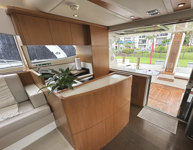 Slide: The Image of Luxurious interior of 2014 Ferretti Yachts 530 with modern wood finishes and open deck view. - 10