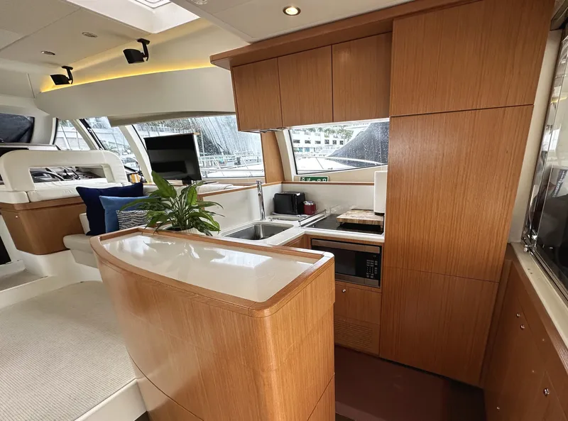 Slide: The Image of Luxurious 2014 Ferretti Yachts 530 interior with modern kitchen and elegant wood finishes. - 13
