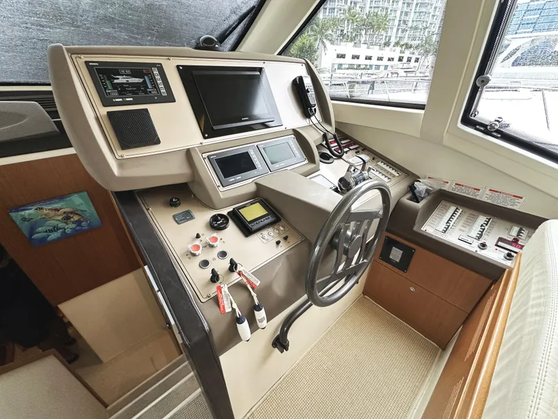 Slide: The Image of Helm of 2014 Ferretti Yachts 530 with modern navigation controls and steering wheel. - 19