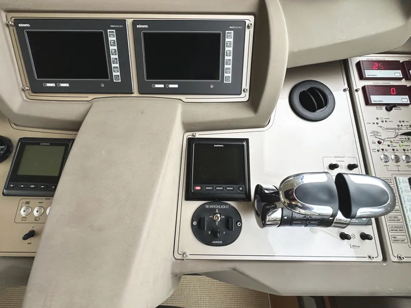 Slide: The Image of Control panel of a 2014 Ferretti Yachts 530 with navigation screens and throttle controls. - 22