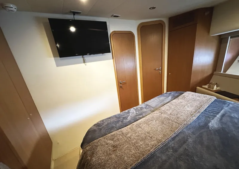 Slide: The Image of Luxurious bedroom interior of 2014 Ferretti Yachts 530 with TV and wooden accents. - 37