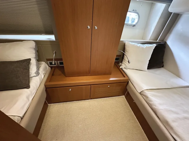 Slide: The Image of Luxurious cabin interior of 2014 Ferretti Yachts 530 with twin beds and wooden cabinetry. - 40