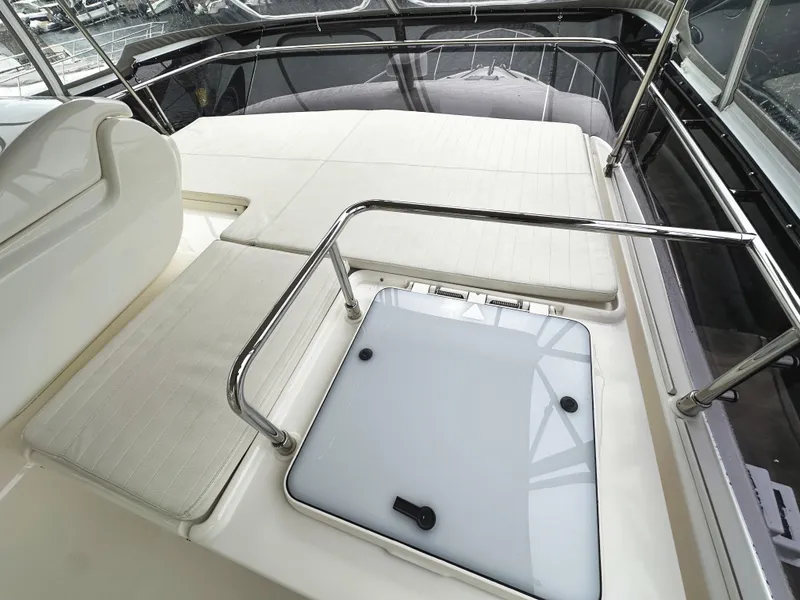Slide: The Image of Luxurious 2014 Ferretti Yachts 530 deck with cushioned seating and sleek railing. - 47