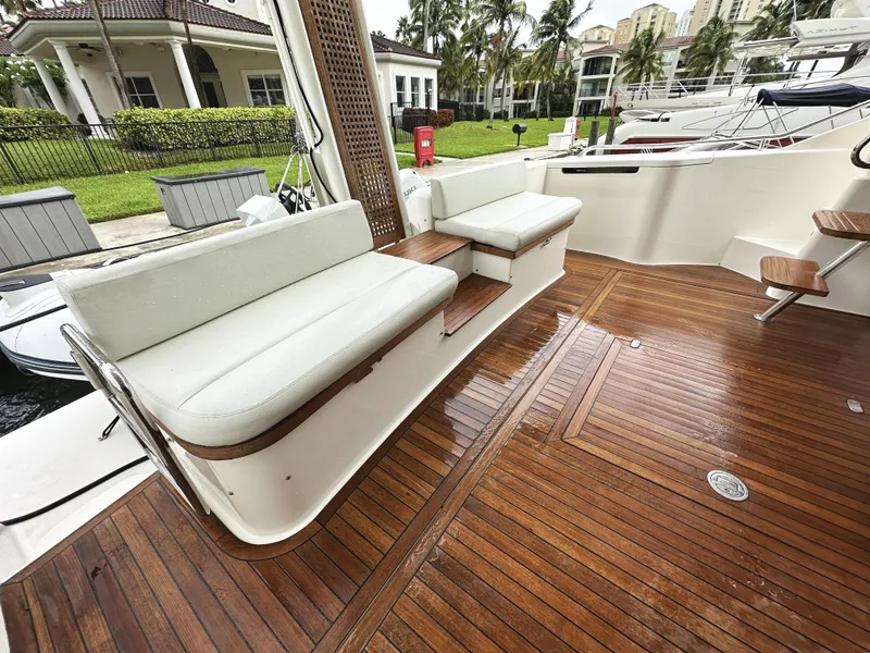 Slide: The Image of Ferretti Yachts 530, 2014 model, featuring elegant teak deck and white seating. - 7