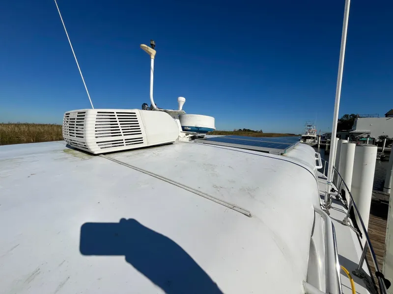 Slide: The Image of 1987 Sea Ray 460 boat roof with equipment under clear blue sky. - 10