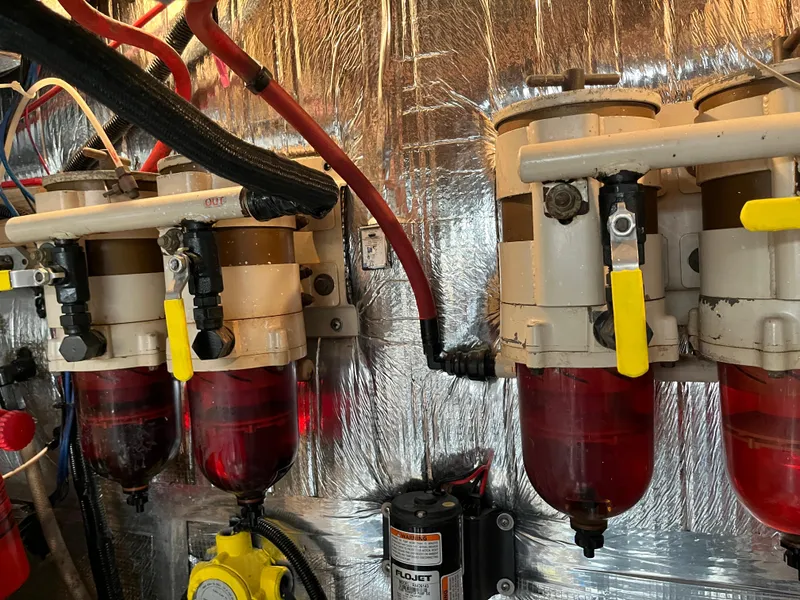 Slide: The Image of Engine room of 1987 Sea Ray 460 with fuel filters and hoses. - 11