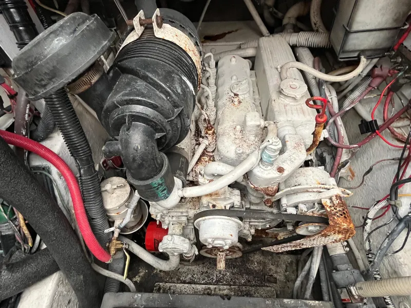 Slide: The Image of Engine compartment of a 1987 Sea Ray 460 boat, showing mechanical components and wiring. - 12