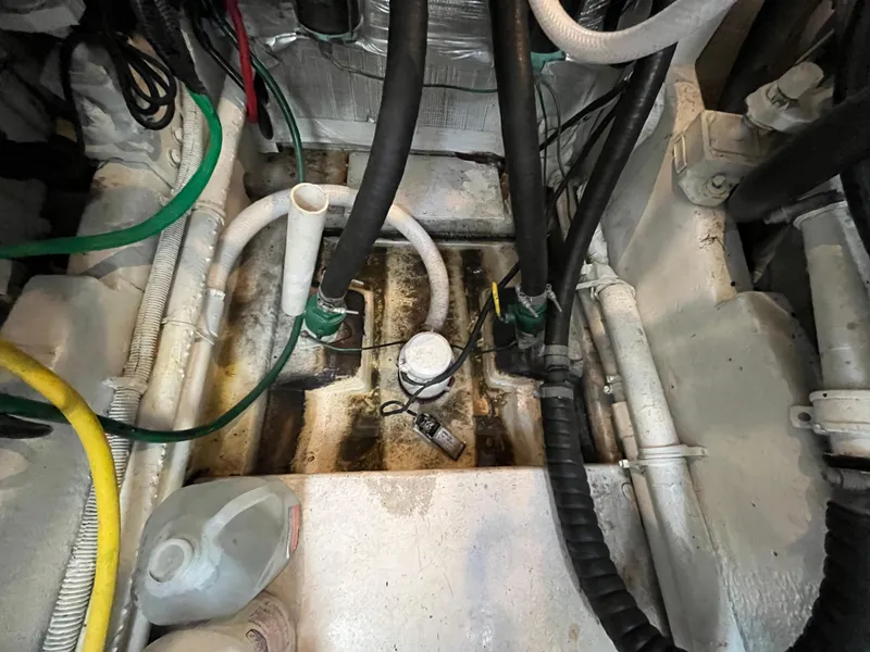 Slide: The Image of Engine compartment of a 1987 Sea Ray 460 boat, showing hoses and maintenance equipment. - 14