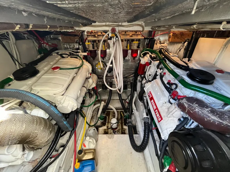 Slide: The Image of Engine room of a 1987 Sea Ray 460 boat, showcasing dual engines and mechanical components. - 15