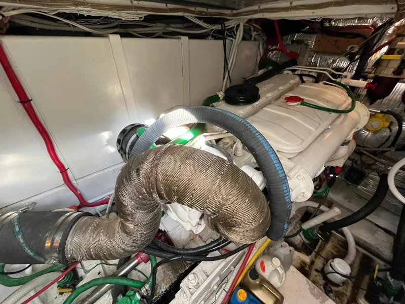 Slide: The Image of Engine room of 1987 Sea Ray 460 boat, featuring complex wiring and components. - 16