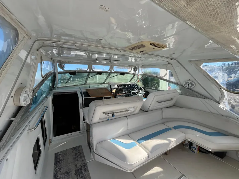 Slide: The Image of Interior of 1987 Sea Ray 460 yacht with white seating and helm. - 17