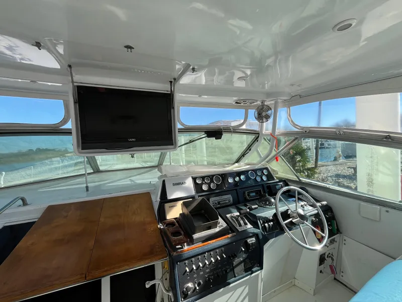 Slide: The Image of Interior view of 1987 Sea Ray 460 boat cockpit with steering wheel and control panel. - 20