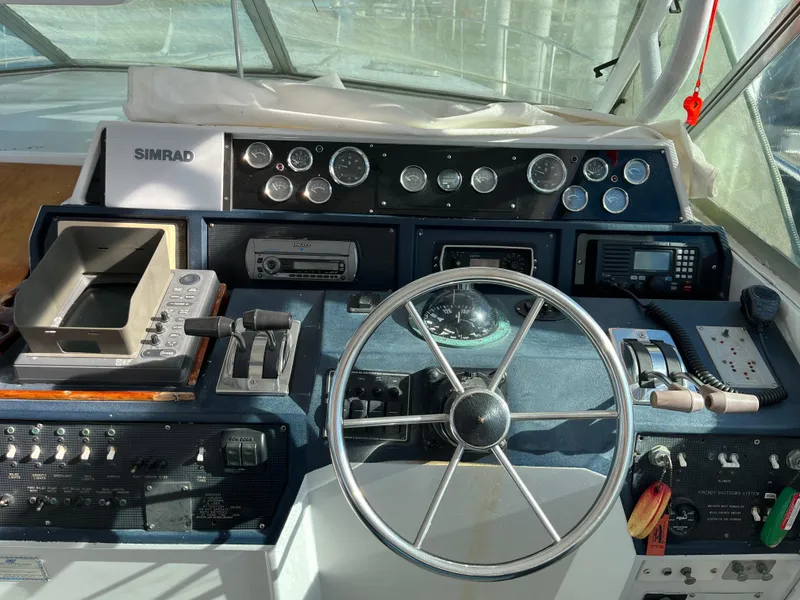 Slide: The Image of 1987 Sea Ray 460 helm with steering wheel, gauges, and navigation equipment. - 22