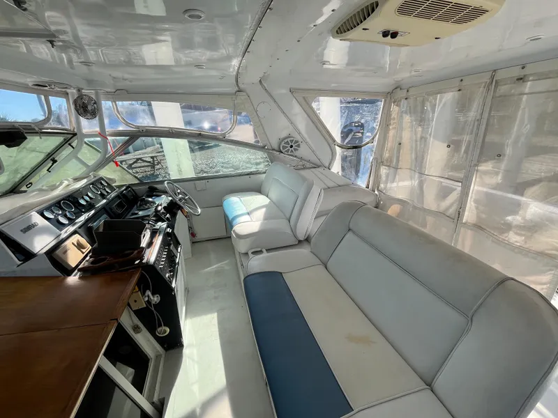 Slide: The Image of Interior of 1987 Sea Ray 460 yacht with spacious seating and modern dashboard. - 28