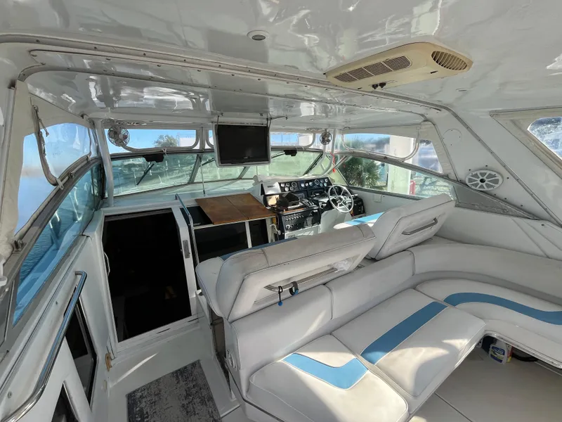 Slide: The Image of Interior of a 1987 Sea Ray 460 yacht with white and blue seating. - 29