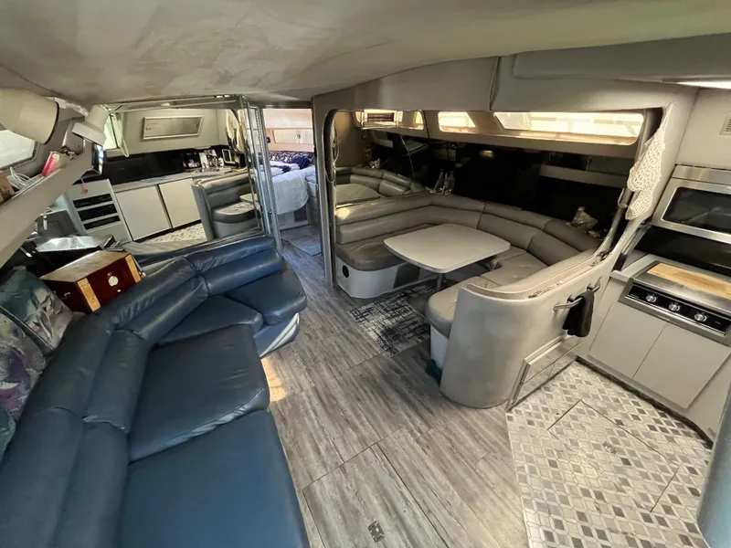 Slide: The Image of Interior of a 1987 Sea Ray 460 yacht with modern seating and kitchen area. - 30