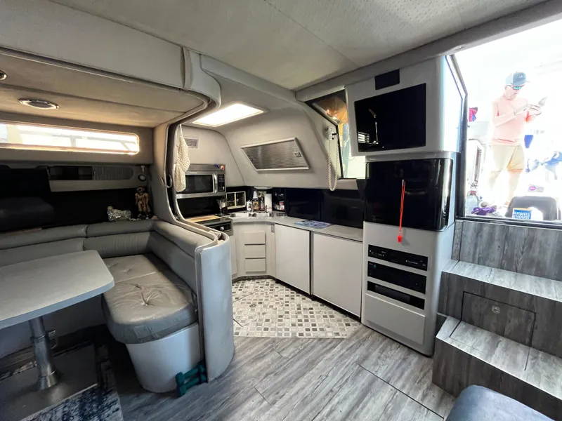 Slide: The Image of Interior of 1987 Sea Ray 460 yacht with modern kitchen and seating area. - 32