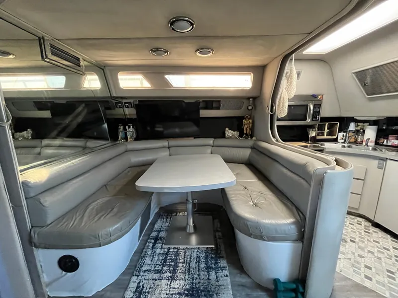 Slide: The Image of Interior of 1987 Sea Ray 460 yacht with cozy seating and modern amenities. - 33