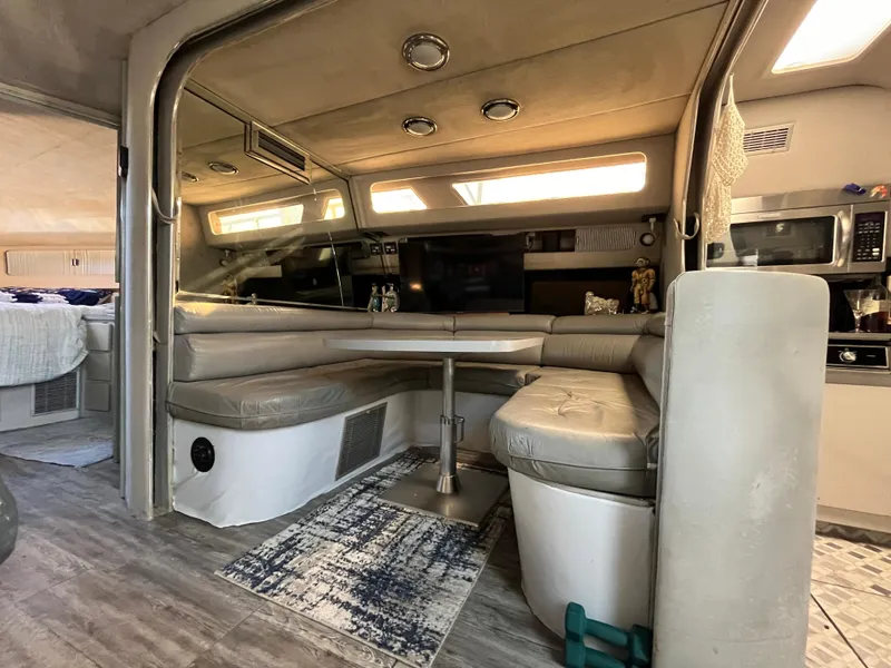 Slide: The Image of Interior of 1987 Sea Ray 460 yacht with cozy seating and modern amenities. - 35