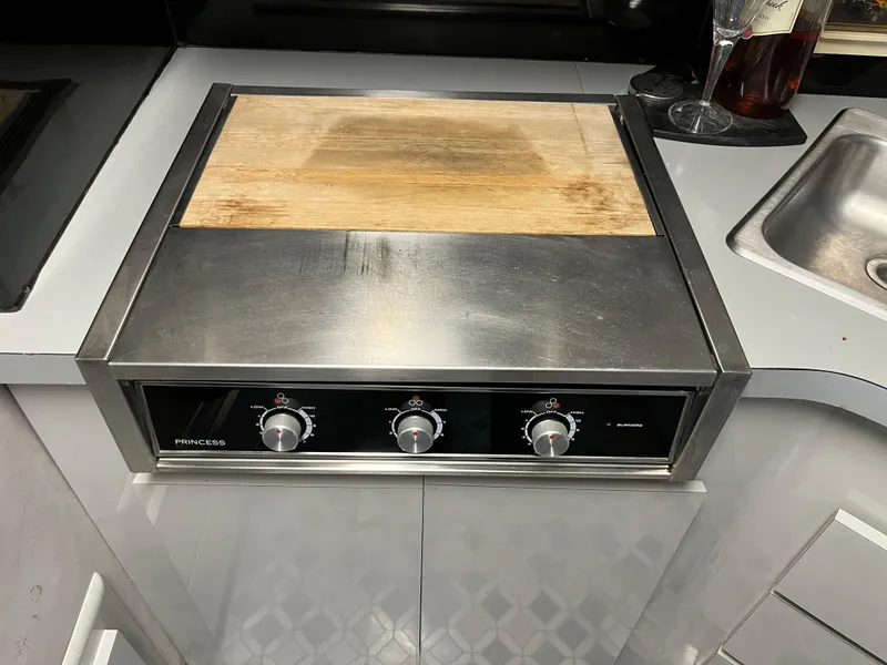 Slide: The Image of Stainless steel stove with wooden cover in 1987 Sea Ray 460 yacht kitchen. - 41
